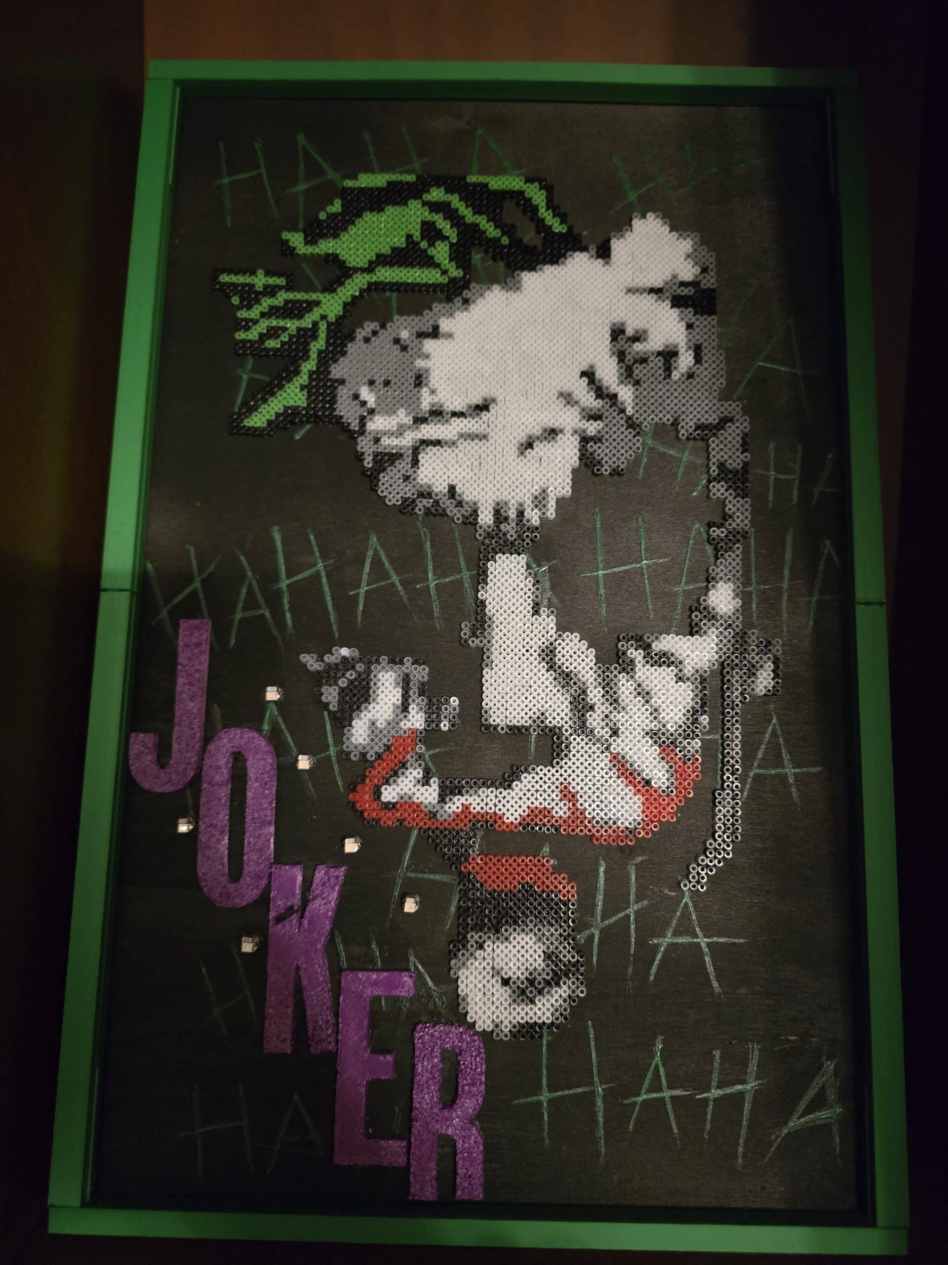Joker pixel art in black, white, green, and purple, inspired by the comic character.